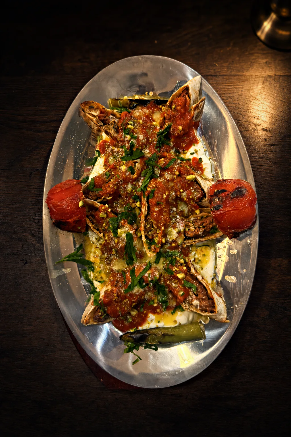 Fıstıklı sarma beyti — adana kebab rolled in lavash with yoghurt, pistachio and tomato sauce