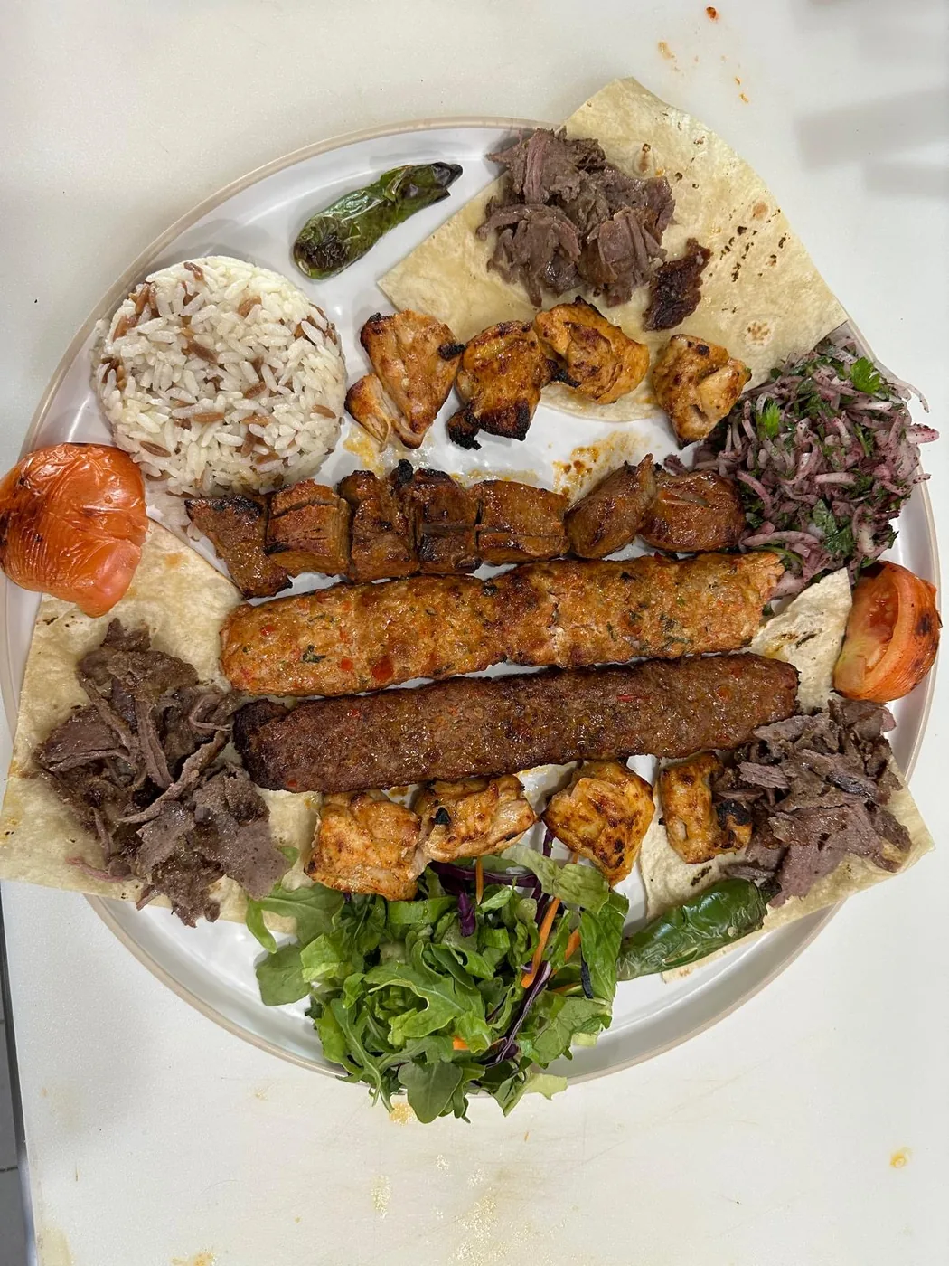 Mix grill platter with adana kebab, chicken shish, döner, rice and salad
